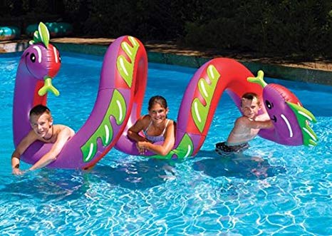 Three young teenagers in swimwear playing and relaxing in the pool