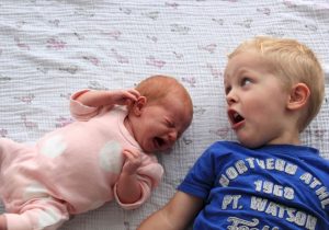 Image showing a boy shouting to his cute little baby brother