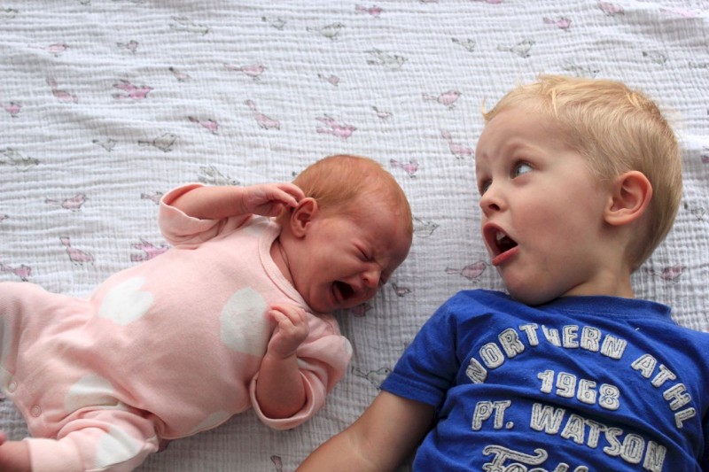 Image showing a boy shouting to his cute little baby brother
