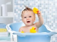 Image showing a beautiful little kid playing with bubbles and toys.