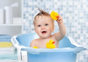 Image showing a beautiful little kid playing with bubbles and toys.