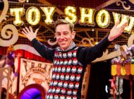 Image Showing A Smiling man warm welcoming the guest for the toy show