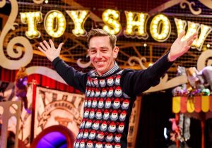 Image Showing A Smiling man warm welcoming the guest for the toy show